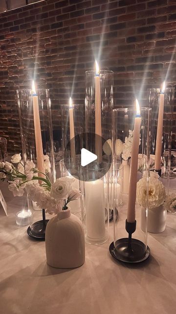 Austin Dziwinski | Boutique Floral Designer on Instagram: "Come set up a round table with me ✨ — Check out one of our round table designs from last nights wedding. We will unpack all the gorgeous details this week! • this design (1 of 2) was more “candle heavy” and complimented the “industrial” features in the room. We used multiple levels of lighting through 3 different variations of candle light (tapers, pillars and tea lights) in order to create a full, textured look. The black metal holders ft antique beige taper candles illuminated warm light and beauty from all angles. They were the perfect contrast against our soft white, lush budvases (no foliage here) just marshmallows, dancing all over the room ✨ . . More to come!!!! Stay Tuned!!! . . . . #weddingdecor #weddinginspo #tableset Taper Candles Wedding, Round Wedding Tables, Black Taper Candles, Circle Table, Round Candles, Iron Candlesticks, Candleholder Centerpieces, Table Designs, Wedding Set Up