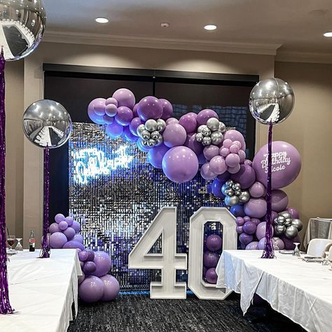 Turning 40 never looked so fabulous! 🎉✨ Celebrate in style with this stunning balloon decor featuring shades of purple and silver accents, complemented by a glowing neon sign saying ‘Let’s Celebrate’ over a shimmering silver backdrop together, creating the perfect combination for a fabulous birthday celebration. Purple And Silver Backdrop, 40th Birthday Ideas For Women Purple, Purple Decorations Party Birthday, Purple And Silver Birthday Party, Purple Themed Birthday Party, Silver Backdrop, Purple Party Decorations, 90s Prom, Silver Party Decorations