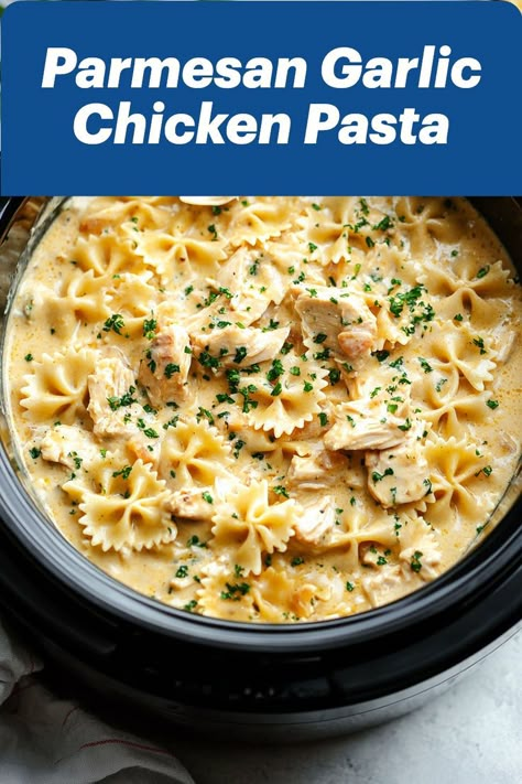 A creamy bowl of Crockpot Parmesan Garlic Chicken Pasta featuring tender chunks of chicken, perfectly cooked farfalle pasta, and a rich garlic-Parmesan sauce. Topped with fresh parsley, this hearty pasta dish is a comforting blend of flavors, making it an ideal choice for easy weeknight dinners. Parmesan Garlic Chicken Pasta, Crockpot Garlic Parmesan Chicken Pasta, Crockpot Garlic Parmesan Chicken, Crockpot Fall Recipes, Parmesan Garlic Chicken, Garlic Parmesan Chicken Pasta, Quick Crockpot Meals, Parmesan Chicken Pasta, Creamy White Wine Sauce