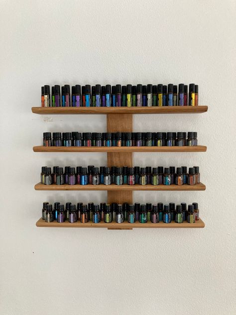 This wall-mounted oil shelf is ideal for anyone who uses oils with 15ml, 5ml and RollOns 10ml bottles. It offers space for 54 oil bottles (diameter 29 mm) 31 oil bottles with 5ml content (diameter 24 mm) and 31 RollOns with 10ml bottle content (diameter 22 mm) The shelf is made of oak wood. There are four floors with 27 or 31 parking spaces each The wood is treated with walnut oil. There is a device on the back of the vertical strut for easy Mounting on the wall. Screws are recommended for this. Wall Shelf Display, Oil Shelf, Essential Oil Shelf, Walnut Oil, Essential Oil Bottles, Wooden Stand, Oil Bottle, Wall Shelf, Doterra