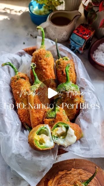 Rafia Mazhar on Instagram: "HERE'S HOW TO MAKE IT ⤵️ Make it at Home Episode 10: Nando's Peri Peri Bites 🌶 Chicken Filling 1 chicken breast in strips 2 tbsp peri peri sauce • Mix both ingredients and fry on medium heat till cooked Cheese Filling 2 tbsp shredded mozzarella cheese 2 tbsp shredded cheddar cheese 1 tbsp cream cheese 2 tbsp mayonnaise • Mix all the ingredients together fill in a piping bag Chillis 8 to 10 medium sized green chillies Water 1 tbsp vinegar Breading Flour Egg Breadcrumbs • Wash the chillies and dry. Make a T shaped incision on one side and remove all seeds from the inside (tap on the chillies to ensure all seeds are out) • Dip the chillies in a bowl of water and vinegar for 10 minutes • Remove the chillies. Dry with kitchen towel and fill each chilli Cooked Cheese, Peri Peri Sauce, Pakora Recipes, Shredded Cheddar Cheese, Peri Peri, Piping Bag, Cheese Bites, Shredded Mozzarella, Mozzarella Cheese