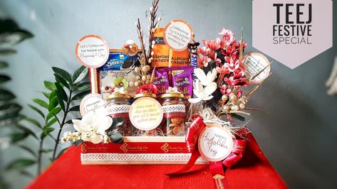 Celebrate Teej Festival with our luxurious gift hampers with customised message cards. Surprise your loved ones with this hamper filled with delicious goodies.    Reach us @ 9100190303 for order bookings and further details.    #teej #festival #indianfestivals #gifthamper #woodenbasket #giftsinstyle #luxuriousgifts #healthygoodies Teej Festival, Chocolate Bouquet Diy, Packing Ideas, Message Cards, Wooden Basket, Chocolate Bouquet, Diy Bouquet, Indian Festivals, Gift Hampers