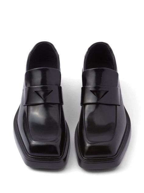 Prada pairs Italian leather craftsmanship with its timeless sleekness in these black leather loafers. Adorned with the signature triangle logo patch, contrast white logo lettering appears at the heel counter for a branding-focused finish. Highlightsblackleathersmoothing finishtriangle logosquare toelogo print to the rearbranded leather insoleleather soleslip-on styleGender: WomenMaterial: 100%CALFColor: BlackMade in: ImportedProduct ID: 1D499NF040055 174795 NERO*Import tax/duty will be calculate Prada Loafers, Square Shoes, Square Toe Shoes, Black Leather Loafers, Triangle Logo, High End Fashion, Leather Loafers, Italian Leather, Loafer Shoes