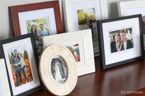 It's time to stop hiding memories behind other memories Picture Frame Table, Display Family Photos, Diy Playbook, Photo Wall Gallery, Picture Ledge, Picture Frame Display, Table Display, Decorating With Pictures, Mantel Decorations