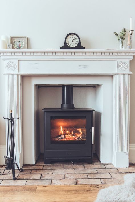 This is my new simple, modern farmhouse look fireplace with a brick tile hearth which cost only £30. Budget decorating at it's finest! We renovated our 1930s living room with rustic, farmhouse, country living home decoration and I decorated the white mantelpiece with simple clock and home accessories to style on the shelf above. Click through to see my whole before and after living room home makeover Stove Fireplace Living Room, Freestanding Fireplace Hearth, Fireplace Ideas Old Style, Victorian Electric Fireplace, Stove Inside Fireplace, Fireplace With Stove, 1930 Interior, Fireplace 2023, Fireplace Heaters