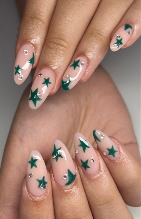 acrylic nails (pink/nude base) with green miss match stars and small dominates Sage Green Nails With Stars, Green Almond Acrylic Nails Designs, Green Star Nails Acrylic, Green And White Star Nails, Sage Green Star Nails, Dark Green Star Nails, Green Stars Nails, Star Christmas Nails, Green Nails With Pearls