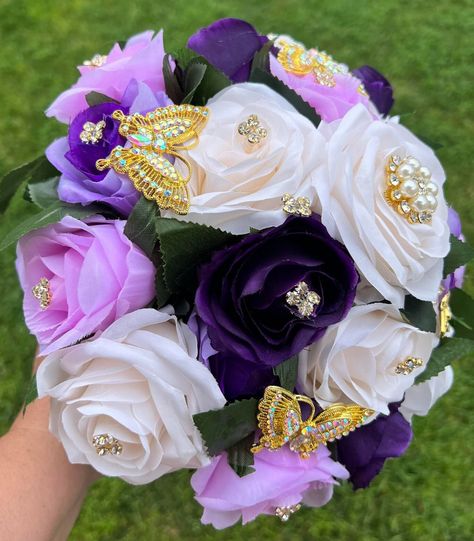 Handmade Quinceañera Bouquet/ Wedding.  With Lavender, Lilac, Purple, Ivory, Pink and Plum Roses. Finished off with Gold brooches and Butterflies.  *Please note brooches can change in style due to availability.* Decor / color combinations can be changed upon request. {This is a made to order Bouquet} Wedding With Lavender, Plum Roses, Quince Bouquet, Quince Colors, Rose Gold Quinceanera, Quinceanera Bouquet, Purple Quince, Gold Bouquet, Crystal Wedding Dresses