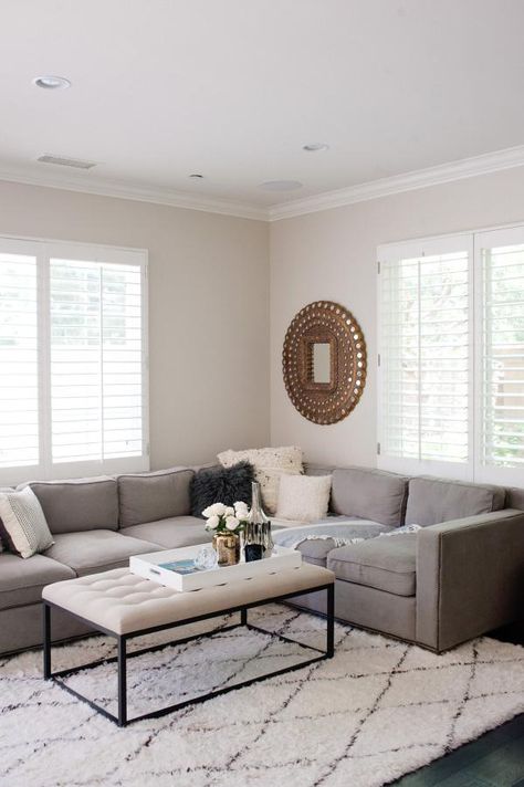 Love this sleek neutral hued living room with gray sectional, black and white diamond print Moroccan rug, tufted iron frame coffee table, and gilded sunburst mirror! Apartment Photography, Neutral Photography, Gray Sectional Living Room, Gray Couch, Gray Living Room Design, Cream Living Rooms, Domestic Bliss, Greenery Decor, Grey Sectional