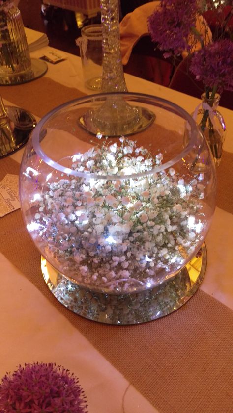 Gypsophila fishbowl with fairy lights Fish Bowl Centerpiece Wedding, Vintage Wedding Decorations Diy, Fishbowl Centerpiece, Thanksgiving Dinner Table Setting, Fairytale Wedding Decorations, Fairy Lights Wedding, Table Centerpieces Diy, Fairy Lights Decor, Lighted Centerpieces