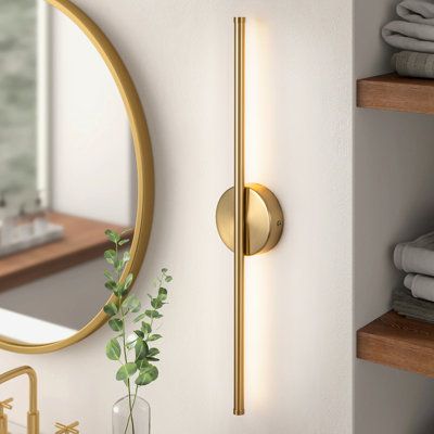 Full of sleek, modern minimalism, this semi-flush mounted sconce illuminates almost any spot you could think of in your home. Crafted from iron with a bold finish, it features a circular backplate and a bar that can be installed vertically or horizontally, depending on your available space and aesthetic. Built into the rod is an LED strip that faces against the wall, casting a bold and dimmable glow in your bedroom or over your bathroom vanity. Our favorite part? This wall light is rated for dam Sconces Bathroom Lighting, Gold Wall Sconces Bedroom, Bathroom Wall Sconces Double Vanity, Dining Room Wall Sconces, Master Bath Sconces, Mid Century Modern Sconces, Florida Bedroom, Terrazzo Bathroom, Gold Sconces