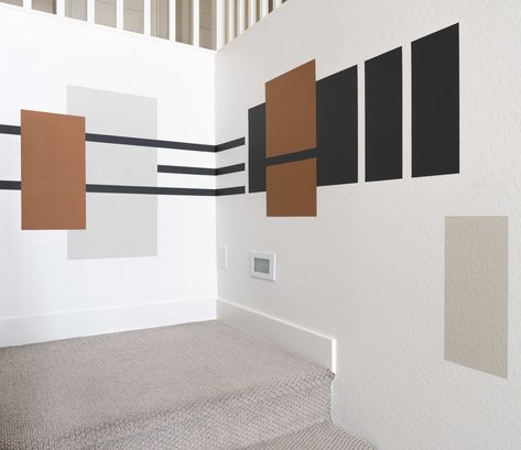 We added a color block design to our staircase landing and love it because it's a custom art piece in our home! When I removed the garlands from our staircase after the holidays, the view was too plain, so we decided to change that with a geometric color-block design. Below I'm sharing the supplies we used to complete this paint Color Block Entryway, Block Wall Painting Ideas, Geometric Feature Wall, Staircase Color, Colour Blocking Interior, Geometric Mural, Stairway Wall, Stairwell Wall, Brown Paint Colors