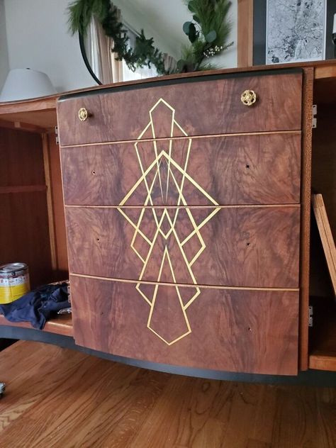 I purchased this buffet on my local Facebook marketplace in hopes to give it a new life and flip it. It was in great shape as far as the veneer, doors and hardware. But I had much more in store for this piece I took of the top hutch part as well as the doors and sanded them down with a sand paper grit 120,220 and 320. I made some sketches and decided to go with option 1. And expose as much of the amazing wood grain as possible. I added a cool art deco design on the front which Art Deco Buffet Makeover, Art Deco Wood Furniture, Art Deco Cabinet Makeover, Art Deco Dresser Makeover, Dresser Repaint, Art Deco Furniture Makeover, Cupboard Upcycle, Art Deco Wall Paper, Art Deco Diy