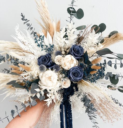 Dried everlasting bouquet including pampas grass, preserved roses, hydrangea, silver Brunia, bunny tail grass, sola wood flowers. Perfect bridal bouquet, bridesmaids bouquet, or place in vase for home decor. Hand tied with silk chiffon ribbon.  -Large Bouquet is approximately 16" (shown) -Medium Bouquet is approx 14" -Small Bouquet is approx 8"  *Each arrangement is handmade to order and we try our best to ship out within the listed processing time. If you need your item sooner, please message m Blue And Wedding Color Schemes, Rustic Bridal Bouquet Dried Flowers, Magnolia And Pampas Bouquet, Cascading Winter Bouquet, Wooden Wedding Flower Bouquets, Navy Blue Wedding Theme Rustic, Cat Tail Floral Arrangements, Rose Gold And Navy Blue Wedding Theme Flowers, Sage Green And Navy Blue Wedding Bouquets