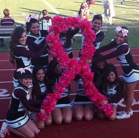 Varsity cheerleaders at our pink out football game Pink Out Football Game Outfits Cheer, Cheerleading Football Game, Cheer Pink Out, Pink Out Football Game Cheerleaders, Pink Out Night Football, Pink Out Cheer, Cheerleading Banners For Football, Pink Football Game, Pink Out Football Game