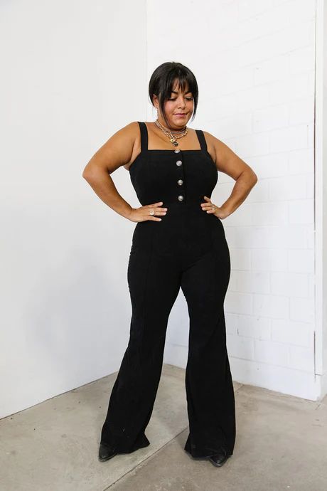 This flattering jumpsuit is made of soft corduroy fabric and features button front details and a trendy bootcut fit. Square neckline Shoulder straps Button front detail (nonfunctioning) Zipper back Boot cut fit Corduroy fabric 97% Polyester/3% Spandex Fit and sizing:  Measurements are approximate. Length measurements a Black Denim Jumpsuit Outfit, Denim Jumpsuit Outfit, Black Denim Jumpsuit, Outfit Western, Corduroy Dungarees, Envy Clothing, Jumpsuit Outfit, Corduroy Fabric, Jumpsuit Black