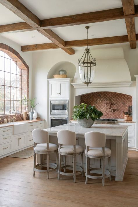 A bright kitchen with a large arched window, white cabinetry, a central island with upholstered stools, and a herringbone brick backsplash under a rustic wooden ceiling Brick Kitchen Backsplash Ideas, Arch In Kitchen, Red Brick Kitchen, Rh Kitchen, Backsplash Kitchen Ideas, Brick Kitchen Backsplash, Herringbone Brick, Brick Backsplash Kitchen, Brick Arch