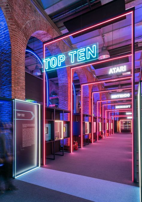 Game On's neon-filled exhibition design pays homage to 80s video games History Video, History Of Video Games, 80s Video Games, Brick Arch, 카페 인테리어 디자인, Laser Tag, Exhibition Booth, Exhibition Space, Stage Design