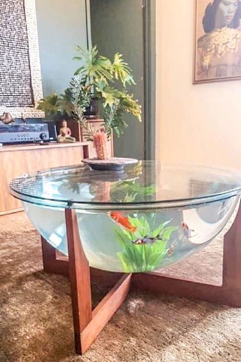 This Unique Glass 🐟 Fish Tank Table with Wooden Legs is Serving as a Center Table. It is Suitable Best for Exotic or Tropical Style Home Designs. This Table act as an Eye-Catching ✨ & Interesting Element for the Visitors of your Home - GharPedia Table Aquarium, Fish Tank Table, Aquarium Coffee Table, Wall Aquarium, Glass Fish Tanks, Fish Tank Terrarium, Aquarium Setup, Danish Furniture Design, Aquarium Design