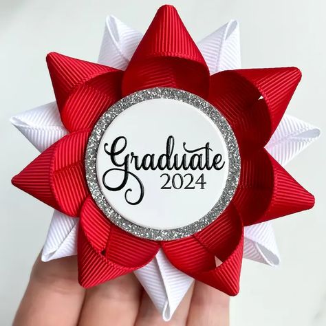 Planning a graduation party? Give the Graduate this custom color Graduate 2024 pin. Handmade from grosgrain ribbon, this pin is shown in Red and White with a Silver glitter detail. The glossy white centerpiece is custom printed in your year with raised ink print. Each pin is 3 1/2" wide and is packaged in a white gift box with bow for safe shipping. Graduation Corsage, Bridal Shower Corsages, Personalized Centerpieces, Flowers For Men, Baby Shower Pin, White Centerpiece, Birthday Pins, Graduation Party Decorations, Baby Shower Corsage