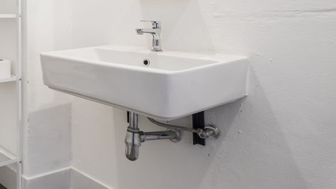 The Stylish Way To Utilize Under-The-Sink Storage Space In Your Bathroom - House Digest Hiding Pipes Under Bathroom Sink, Tiniest Bathroom, Bathroom Sink Diy, Under The Sink Storage, Under Bathroom Sink, Sink Skirt, Floating Sink, Hiding Ugly, Sink Cover