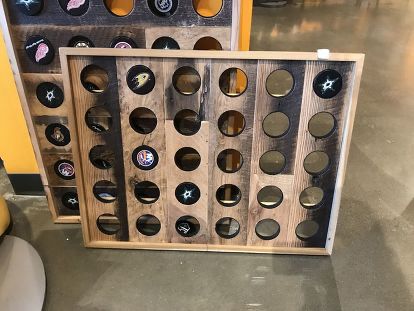 Do you have any hockey lovers in your life? This easy handmade hockey puck display is the perfect gift for the hockey lover in your life. And the even better news?! It is super inexpensive and easy to make too! Hockey Projects, Hockey Puck Display, Nashville Predators Hockey, Cabinet Doors Repurposed, Hockey Room, Timber Shelves, Jersey Display, Recycle Timber, Easy Handmade