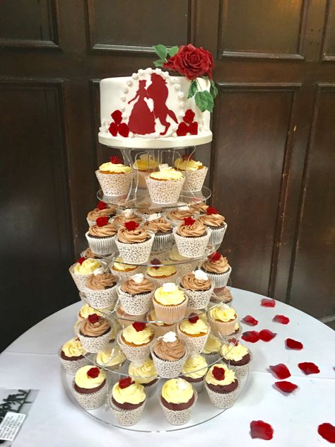 A vanilla sponge overlaid with a beauty and the beast silhouette, surrounded by chocolate, lemon and red velvet cupcakes topped with a handmade rose of love. Beauty And The Beast Wedding Cakes, Pocahontas Wedding, Beauty And The Beast Cupcakes, Beauty And The Beast Wedding Cake, Wedding Cales, Beast Silhouette, Beauty And The Beast Silhouette, Dream Quinceanera, Beauty And The Beast Wedding