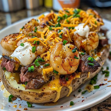 🥔 Steak & Shrimp Loaded Baked Potato: Hearty and luxurious, loaded with juicy steak and shrimp! #LoadedPotatoLuxury Steak & Shrimp Loaded Baked Potato Ingredients: Large potatoes (4) Steak, cubed (1 lb (450 g)) Shrimp, peeled (1/2 lb (225 g)) Butter (4 tbsp (60 g)) Sour cream (1/2 cup (120 ml)) Cheddar cheese, shredded (1 cup (100 g)) Chives, chopped (1/4 cup (25 g)) Instructions: Bake potatoes until tender. Sauté steak and shrimp. Split potatoes, fill with steak, shrimp, butter, sour cre... Steak Bite Baked Potatoes, Steak And Shrimp Stuffed Potatoes, Surf And Turf Loaded Baked Potato, Steak And Shrimp Loaded Baked Potato, Steak And Shrimp Stuffed Bread, Shrimp Alfredo Baked Potato, Chicken And Shrimp Baked Potato, Loaded Baked Potato With Shrimp, Shrimp And Potatoes Recipes