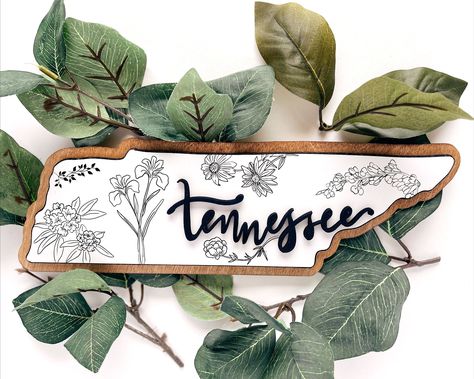 Tennessee wood wall art is a beautiful and unique way to show your love for the Volunteer State. This hand-crafted piece features a map of Tennessee with the state flowers, making it the perfect gift for any Tennessean or fan of the state.

#Tennessee #WoodWallArt #MapOfTennessee #StateFlowers Map Of Tennessee, Alaska Cabin, Diy Laser Engraver, Tennessee House, Tennessee Map, State Flowers, Halloween Costumes To Make, Laser Projects, Laser Ideas