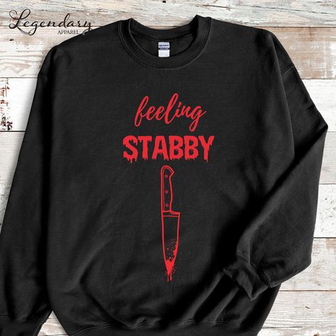 Halloween Sweatshirt Feeling Stabby True Crime Lover Spooky Season Shirt Funny Bloody Horror Movie Knife Sweatshirt Halloween Party Outfit Made on Gildan Crewneck Sweatshirts! 50% Cotton, 50% Polyester 𝗜𝗺𝗽𝗼𝗿𝘁𝗮𝗻𝘁 𝗧𝗶𝗱 𝗕𝗶𝘁𝘀: 🎃 Orders ship in 1-2 business days. 🎃  Need your item sooner? Upgrade to Priority Mail Express at checkout. 🎃  Size charts are available for all styles. 🎃  Colors may vary depending on your computer screen. 🎃  Machine wash cold inside out & tumble dry low. Spooky Season Fashion, Spooky Season Clothes, Horror Movie Outfits Aesthetic, Horror Convention Outfit, Haunted House Outfit Date, Sweatshirt Cricut Ideas, Horror Aesthetic Outfits, Spooky Outfits, Spooky Shirts