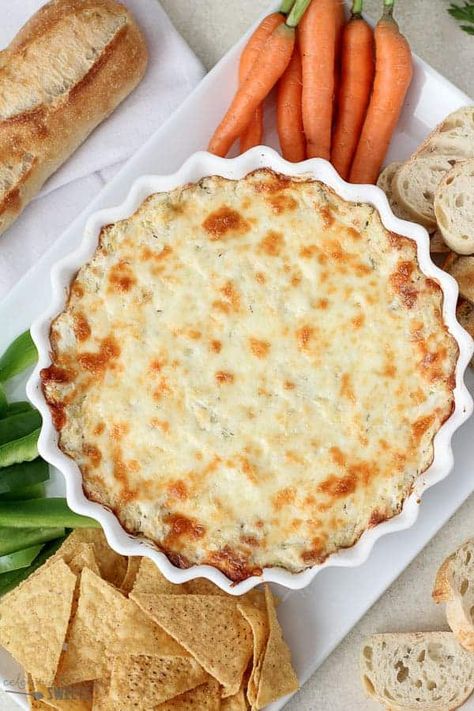 Artichoke dip in a white casserole dish Warm Artichoke Dip, Hot Artichoke Dip, Celebrating Sweets, Artichoke Dip Recipe, Cheesy Dip, Fall Appetizers, Protein Food, Crowd Pleasing Appetizers, Artichoke Recipes