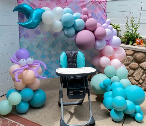 Balloon setup around highchair for “ONE-der the Sea” first birthday party. @popfestcoshop One-der The Sea Birthday, Wonder The Sea First Birthday, Mermaid Birthday Party Balloons, Oneder The Sea 1st Birthday, One Der The Sea, First Birthday Centerpieces, Oneder The Sea, Birthday Party Balloons, 1st Birthday Themes