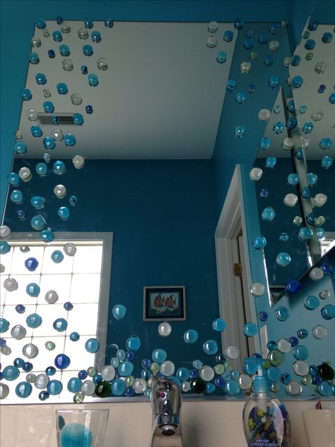 Use Dollar Store glass vase fillers to turn a builders mirror into a beautiful addition to your bathroom. This is an Under the Sea theme kid's bathroom. Under The Sea Bathroom, Sea Bathroom Decor, Ocean Bathroom Decor, Sea Bathroom, Ocean Bathroom, Mermaid Bathroom Decor, Mermaid Bedroom, Mermaid Bathroom, Mermaid Room