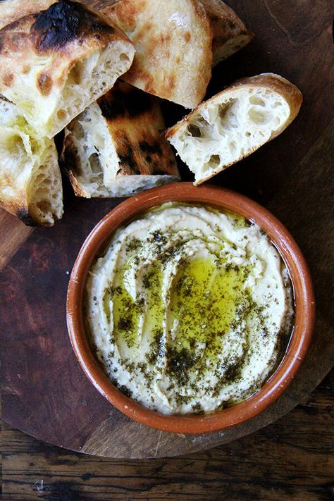 This smoky eggplant dip calls for charring whole eggplant on a grill or over an open flame until the skin is blackened. The rest is easy: pulse the eggplant flesh in a food processor with tahini, Greek yogurt, salt, and fresh lemon, and before serving, drizzle with olive oil and sprinkle with za'atar. Yum. // alexandracooks.com Eggplant Dip, Za Atar, New Cookbooks, Middle Eastern Recipes, Appetizer Dips, Eggplant, Hummus, Appetizer Recipes, Olive Oil