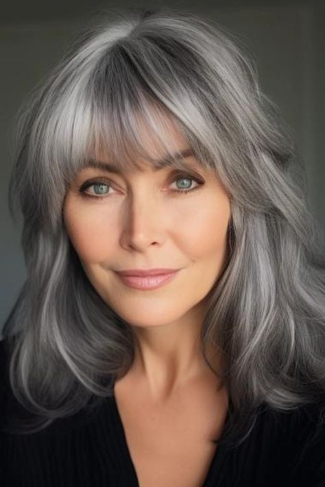 Silver-gray gentle waves with full bangs is a perfectly aged look. With subtle waves, this long bob for women looks utterly graceful. Click here to check out more flattering medium-length hairstyles for women in their 60s. Layered Hair For Thick Wavy Hair, Grey Hair With Bangs, Gray Hairstyles, Beautiful Gray Hair, Bride Gown, Grey Wig, Natural Gray Hair, Layered Bob Hairstyles, Long Gray Hair