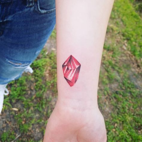 Ruby Crystal Tattoo, Ruby Tattoo Gem, C Section Tattoo, Couple Wrist Tattoos, Ruby Tattoo, Based On Your Birth Month, Random Tattoos, Gem Tattoo, Crystal Tattoo