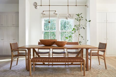 Our classic woven leather bench is as versatile as they come. It can be a warm, inviting landing spot in your foyer or conveniently be used as additional dining room seating while entertaining. This bench has a teak frame featuring turned legs in a nod to mid-century aesthetic and a seat of woven leather straps in our warm-toned saddle. It’s for any space needing a little comfort and style. These leather benches are expertly handcrafted in Bali with Javanese teak wood and leather. There is varia Woven Leather Dining Chair, Woven Dining Chairs, Interior Design Contemporary, Mid Century Aesthetic, Natural Teak Wood, Leather Headboard, Leather Counter Stools, Leather Dining Chair, Dining Room Seating