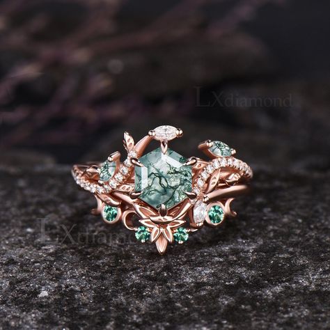 Item description ✦ Handmade, high-quality item! ✦ Material: 925 sterling silver, Solid 10k/14K/18K GOLD (can be made in white/rose/yellow gold) Engagement ring ✦ Center stone: Natural Green Moss Agate. ✦ Size/Weight: 6x6mm Hexagon Cut ✦ Side stones: Marquise Cut Natural Green Moss Agate and Marquise Cut/Round Cut Moissanites Wedding band ✦ Gemstones: Round Cut Lab Emeralds Any ring size can be made,if the ring size is not in the option list ,contact me. As it is handmade,it needs 3-4 weeks to finish and then be shipped by usps or DHL. Return policy: We offer 30 days return policy. For any reason, if you are not completely satisfied with your order, you may return it for a refund.  Buyer is responsible for the handcraft fee (15%-30% of the total price) and the return shipping cost. Unique Engagement Rings Nature Inspired, Enchanted Forest Ring, Non Traditional Wedding Rings Engagement, Green Rings Engagement, Green And Gold Ring, Green Wedding Ring, Green Wedding Rings, Rose Gold Emerald Ring, Nature Wedding Ring