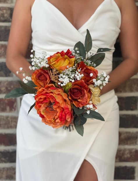 "This exquisite bouquet is made with burnt orange/terracotta roses, orange dahlias and hydrangeas, orange peonies, eucalyptus and baby's breath to give a sweet, elegant look to your wedding. The handle of the bouquet is wrapped with ivory satin ribbon. If you would like the wrap of the bride bouquet different from your bridesmaids or vise versa, please feel free to look around my shop for ideas and let me know how I can customize it for you. Want to add burlap, other colors, brooches? I will gl Rustic Orange Bouquet, Small Orange Bouquet, Orange Prom Bouquet, Simple Fall Wedding Bouquets, Orange And Green Bouquet, Rusty Orange Wedding, Orange Bouquet Wedding, Terracotta Roses, Burnt Orange Wedding Bouquet