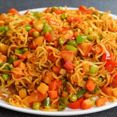 140 gm maggi noodles
    1 teaspoon butter
    1/4 cup peas
    1 tomato
    1 green chilli
    1/4 teaspoon garam masala powder
    12 gm maggi masala
    1/4 teaspoon powdered black pepper

    1/2 onion
    1/2 teaspoon garlic paste
    1/4 teaspoon powdered turmeric
    1/2 capsicum (green pepper)
    1/4 tablespoon red chilli powder
    1/2 teaspoon chaat masala powder
    salt as required
    2 1/2 cup water Masala Maggi, Vegetable Masala, Love Bites, Pad Thai, Ethnic Recipes