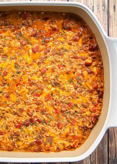 Taco Rice Bake - an easy one-pan Mexican casserole. Ground beef, taco seasoning, rice, cream of chicken soup, Rotel diced tomatoes and green chiles, Ranch style beans, and cheese. We like to top the casserole with our favorite taco toppings - cheese, sour cream, jalapeños, and guacamole! Can make in advance and refrigerate or freeze for later. This was a great change to our usual taco night!! #casserole #mexican #taco #rice #freezermeal Taco Rice Bake, Seasoning Rice, Casserole Ground Beef, Ranch Style Beans, Casserole Mexican, Rice Bake Recipes, Mexican Chopped Salad, Rotel Recipes, Chicken Thights Recipes