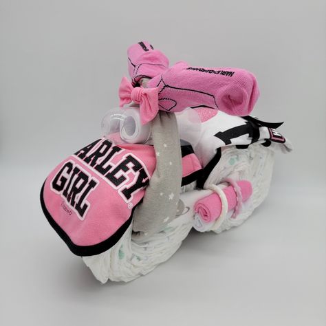 Pink Harley Davidson Motorcycle Diaper Cake Ingredients: 30+ Diapers 1 Harley Davidson Onesie 1 Pair Of Harley Davidson Socks 1 Harley Davidson Bib 2 Receiving Blankets 4-6 Wash Cloths 4 Toy Rings 1 Bottle Ribbon Decorations *** Traditional Harley Davidson Colors Are Available As Well *** *** Please Message Me With The Onesie, Sock, And Bib Set You Prefer. If I Don't Hear From You, Then I Will Choose A Set. The Smaller Socks Go With Smaller Onesies (Mostly 9/12 Month Size) While The Larger Socks Harley Davidson Baby Shower, Baby Shower Motorcycle, Toy Rings, Pink Harley Davidson, Motorcycle Diaper Cake, Harley Davidson Kids, Harley Baby, Diaper Motorcycle Cake, Unique Diaper Cakes