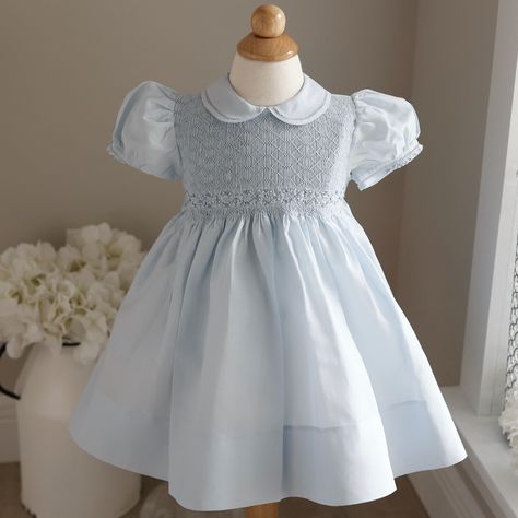 This Light Blue Smocked Baby Girl's Heirloom Dress Is Precious!! Done By Feltman Brothers (Fine Children's Apparel), This Little Dress Has Details Galore!! The Entire Bodice Is Smocked And Has A Lattice Design Embroidery Done In A Blue Threading. Just Above The Gathers Of The Waist Is A Blue Embroidered Chevron Border. Just Above That Is A Gorgeous Hand-Embroidered Garland Of Blue And White Floral Wreaths. The Short Puff Sleeves Have A Double Trim Hem, Joined Together By Hand-Faggoted Stitches ( Embroidered Garland, Feltman Brothers, Baby Pageant, Smocked Baby Clothes, Heirloom Portraits, White Baby Dress, Hand Smocked Dress, Wedding Options, Heirloom Dresses