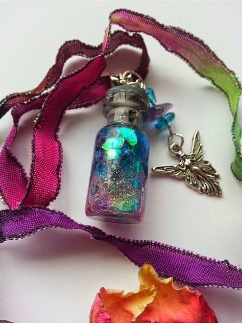 What a gorgeous mixture of colors in this snow globe like potion captured in this miniature, upcycled glass bottle! I just added some new photos! The unique, hand dyed RIBBON WILL BE slightly DIFFERENT as it is custom dyed and the colors fall differently for each necklace. Some have more pink or Photography Embroidery, Embroidery Photography, Fairy Potion, Flowers Water, Magic Fairy, Magic Bottles, Green Magic, Mini Glass Bottles, Magic Potion