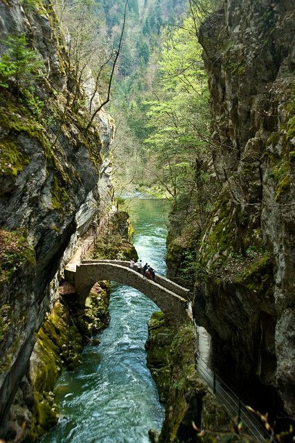 Gorges de l'Areuse, Switzerland. The Val de Travers is a Jura mountain valley perpendicular to the main valleys (hence the name). The river Areuse has cut itself steeply through the soft limestone and clay sediments. Following the river makes for a very scenic walk. Val de Travers Neuchatel Switzerland, Best Places In Switzerland, Places In Switzerland, Visit Switzerland, Mountain Valley, A Bridge, Future Travel, Beautiful Places In The World, Alam Yang Indah