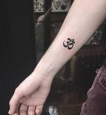 Minimalistic Om tattoo located on the inner forearm. Unalome With Om Tattoo, Om Tattoo Minimalist, Sanskrit Tattoo Symbols Inner Peace, Ohm Wrist Tattoo, Buddha Unalome Tattoo, Inner Forearm, Om Tattoo, Little Tattoos, Tattoo Studio