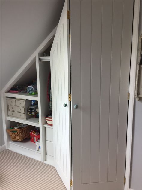 An angled ceiling bi-fold wardrobe and shelves we made and fitted recently. The doors are made from MDF with groove panels and have a hand painted finish. Attic Bedroom Ideas Angled Ceilings, Slanted Ceiling Bedroom, Bedroom Attic, Fitted Wardrobes Bedroom, Attic Wardrobe, Angled Ceiling, Attic Bedroom Designs, Attic Closet, Angled Ceilings