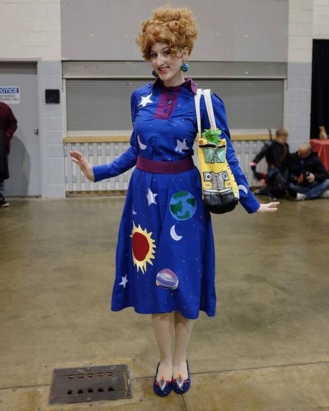 My Ms. Frizzle from The Magic School Bus Cosplay! Such a blast to make & wear! I did modify this dress a bit. The Sun, the 8 Planets + Pluto are depicted on the dress. A bunch of rhinestones were added for sparkle and I did change the earrings from Saturn to Earth. These changes were based simply on personal preference!   Photo By: George Qadado Ms Frizzle Cosplay, Ms Frizzle Dress, Miss Frizzle, 8 Planets, The Magic School Bus, Ms Frizzle, Halloween Costumes For Work, School Costume, Magic School Bus