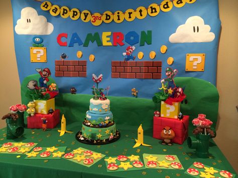 Mario birthday party treat table decor and cake Mario Kart Birthday Decor, Super Mario Cake Table, Mario Table Decorations, Mario Bros Cake Table Decor, Super Mario Sweet Table, Super Mario Birthday Backdrop, Super Mario Brothers Party, Mario Brothers Birthday Party, Mario Kart Party