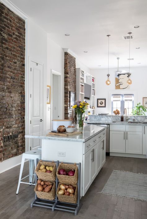 "I love New Orleans’ signature high ceilings. I’m a tall guy at 6’4”, so 12’ ceilings were a must. I also love that the original brick fireplaces simultaneously help to define the separate spaces and maintain the home's historical charm. Sadly, they don’t work, but they look great," says Luke. Credit: <a href="jacquelinemarque.com">Jacqueline Marque</a> New Orleans Shotgun House, Not Minimalist, Shotgun House Interior, New Orleans Decor, Brick Fireplaces, Large Open Kitchens, Shotgun House, Louisiana Homes, Narrow Lot House Plans