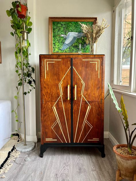 SOLD** This piece has been sold- please do not order. If you are interested in having similar work done, please message me about commissioned work options. Thank you.  A mid-century C.W.S Cabinet Factory, Birmingham wardrobe turned Art Deco bar or cocktail cabinet that is now properly fit.  This British beauty has a new interior, clad in a gorgeous green paint and chic wallpaper. The tempered glass shelves and mounted racks allow plenty of display space, while the large shelf is a perfect serving area. The original walnut finish and brass and Bakelite hardware have been enhanced with a bit of black paint and a hand painted brass design on the front doors. Smashing, if I do say so myself.  Dimensions- Overall- Height: 48 in. Width- 30 in. Depth- 18 in. Inside space- Height: 41 in. Width: 29 Latest Wooden Sofa Set Designs, Deco Bar, Art Deco Cocktail, Antique Wardrobe, Art Deco Bar, Art Deco Bedroom, Drink Bar, Art Deco Cabinet, Cocktail Cabinet